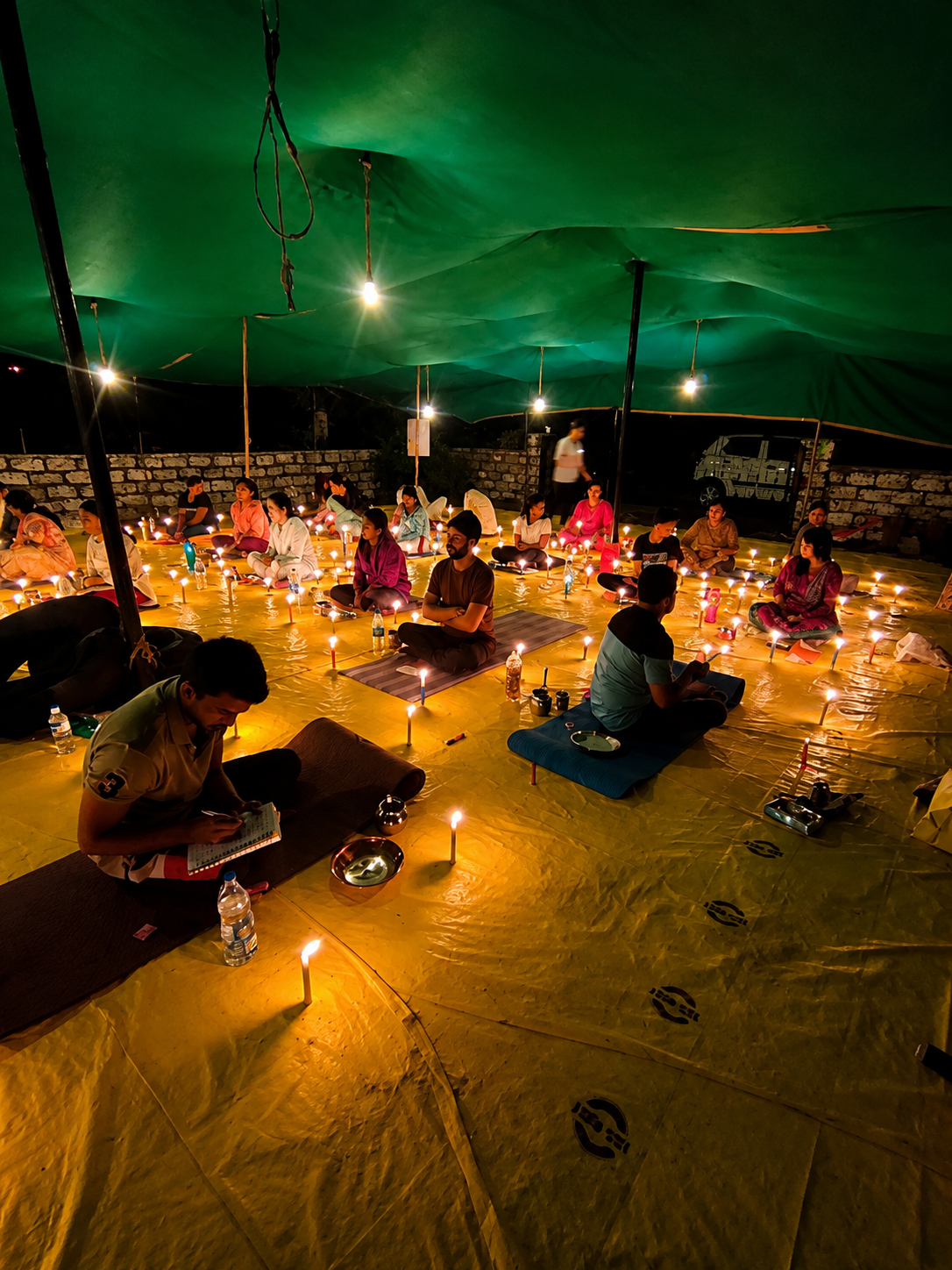 Practitioner in prayer pose by ocean during pranayama session